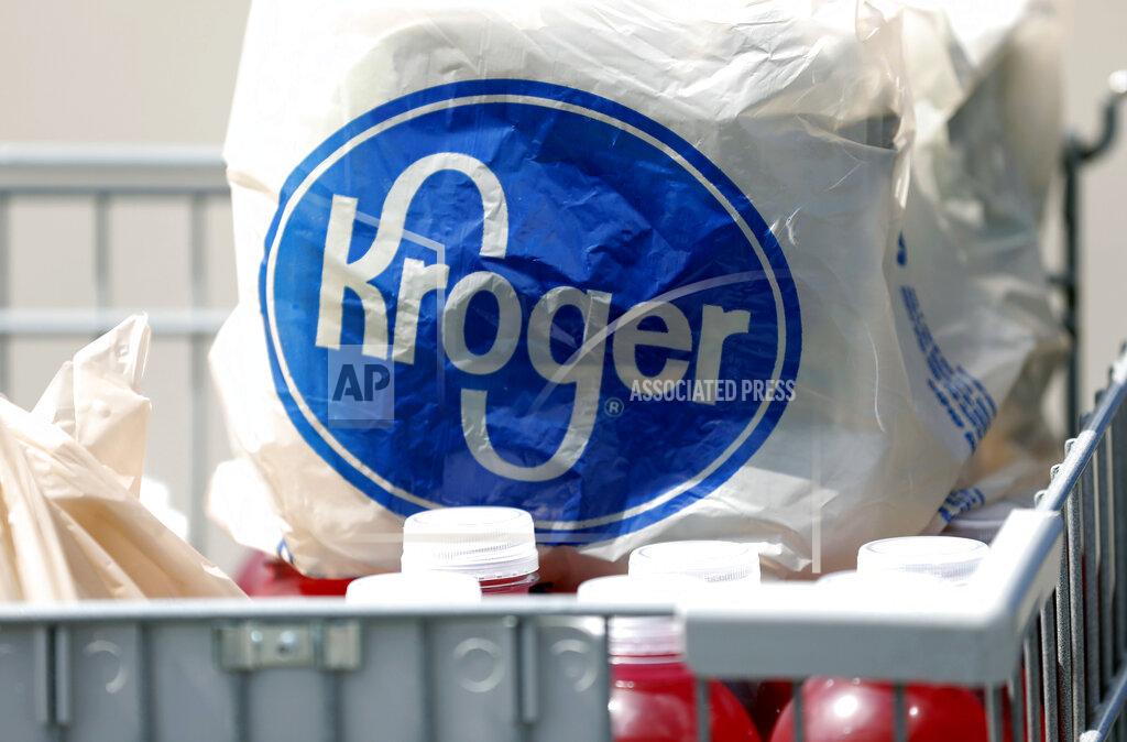 FILE- In this June 15, 2017, file photo bagged purchases from a Kroger grocery store sit in a shopping cart in Flowood, Miss. Kroger’s sales surged in the third quarter, continuing to benefit from people stocking up on groceries as they stay home amid the pandemic. The grocery chain boosted its full-year outlook, partly on the expectation that trends in at home food consumption will continue for the rest of its fiscal year. (AP Photo/Rogelio V. Solis, File)