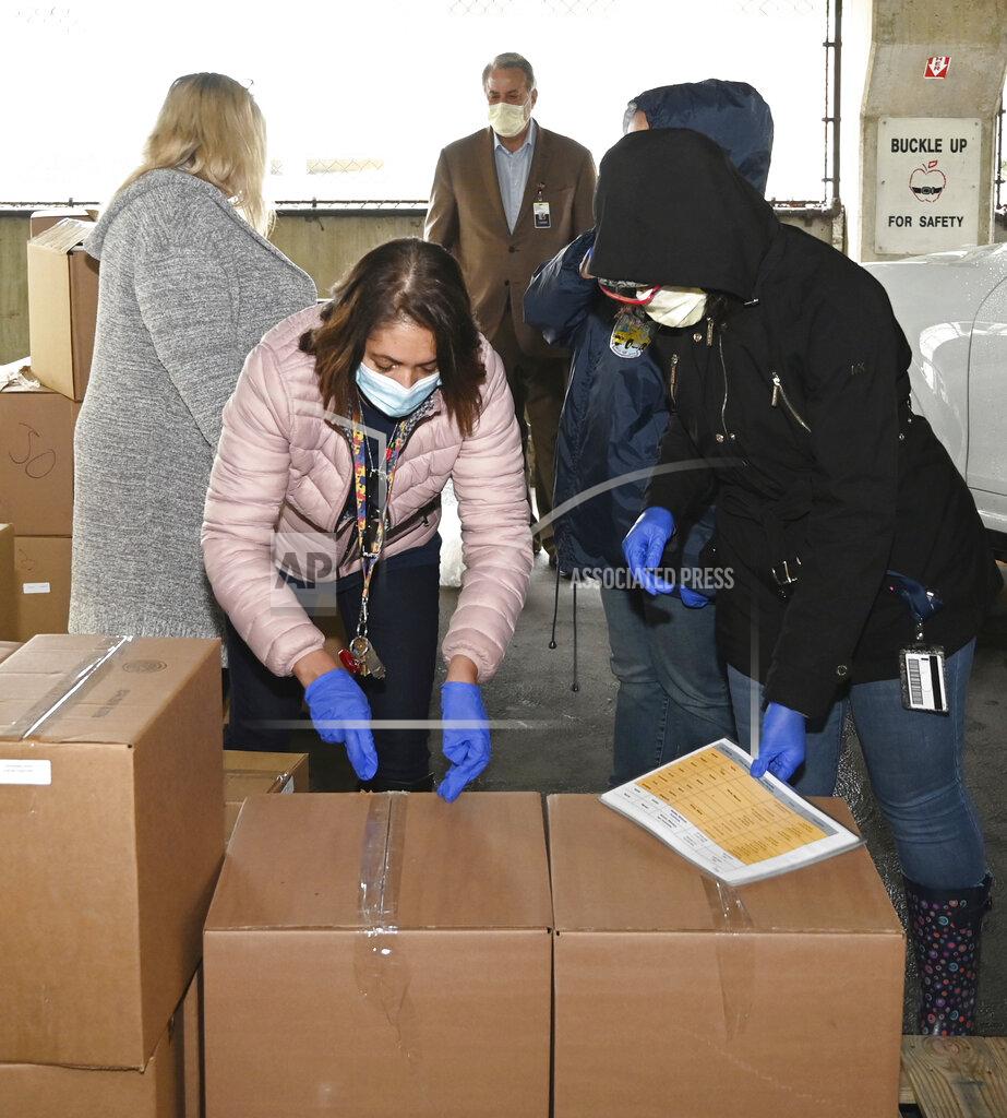 Rudolph Lauletta Jr. In a photo provided by Project Isaiah, volunteers assisting the Project Isaiah food-relief effort transfer boxes of items in an area outside St. Christopher’s Hospital for Children in Philadelphia on April 24, 2020. The prepackaged meals later were distributed to thousands of families in the city. (Rudolph Lauletta Jr./Project Isaiah via AP)