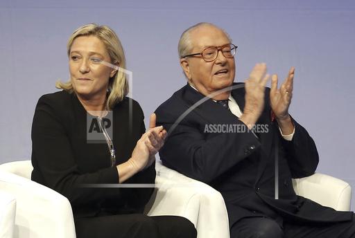FILE - In this Saturday Nov. 29, 2014 file photo, French far-right Front National leader Marine Le Pen and her father Jean-Marie Le Pen applaud in Lyon, central France. A march against antisemitism this weekend in Paris, with the prime minister, government members, political parties and citizens in attendance, is fraught with discord over the planned presence of far-right leader Marine Le Pen. Her father and party founder Jean-Marie Le Pen has been convicted numerous times of antisemitism and racism. (AP Photo/Laurent Cipriani, File)