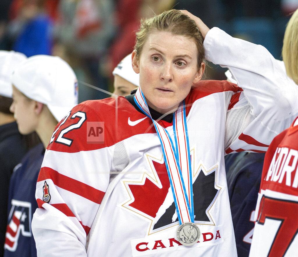 Ryan Remiorz FILE - In this April 4, 2016, file photo, Team Canada's Hayley Wickenheiser wears her silver medal after losing 1-0 to Team USA in the gold medal game at the women's world hockey championships in Kamloops, British Columbia. Regional Olympic officials are rallying around the IOC and have backed its stance on opening the Tokyo Games as scheduled. Their support comes one day after direct criticism from athletes amid the coronavirus outbreak. “I think the IOC insisting this will move ahead, with such conviction, is insensitive and irresponsible given the state of humanity,” said Wickenheiser, a four-time Olympic hockey gold medalist from Canada. (Ryan Remiorz/The Canadian Press via AP, File)