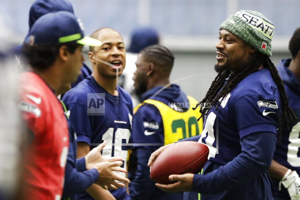 Ted S. Warren Seattle Seahawks running back Marshawn Lynch, right, warms up near quarterback Russell Wilson, left, and wide receiver Tyler Lockett, second from left, before NFL football practice, Friday, Dec. 27, 2019, in Renton, Wash. (AP Photo/Ted S. Warren)