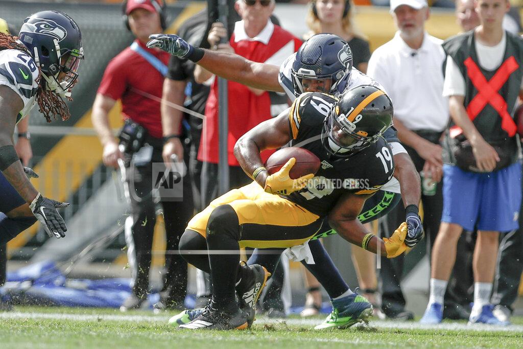 Don Wright Pittsburgh Steelers wide receiver JuJu Smith-Schuster (19) tries to Geta away from Seattle Seahawks outside linebacker K.J. Wright, top, in the second half of an NFL football game Sunday, Sept. 15, 2019, in Pittsburgh. (AP Photo/Don Wright)