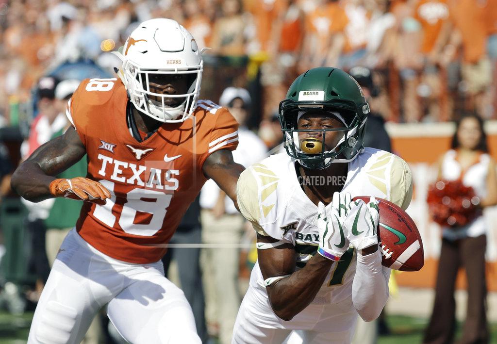 Eric Gay Baylor wide receiver Denzel Mims (15) makes a 19-yard catch in front of Texas defensive back Davante Davis (18) defends the play during the first half of an NCAA college football game, Saturday, Oct. 13, 2018, in Austin, Texas. (AP Photo/Eric Gay)