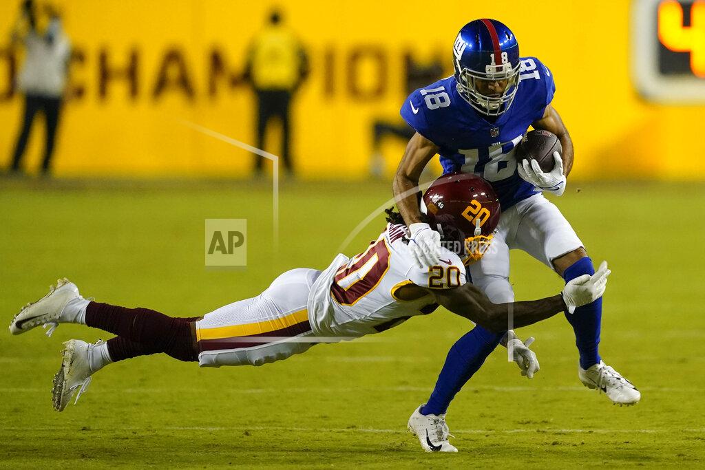 Al Drago New York Giants wide receiver C.J. Board (18) is tackled by Washington Football Team cornerback Bobby McCain (20) during the first half of an NFL football game, Thursday, Sept. 16, 2021, in Landover, Md. (AP Photo/Al Drago)