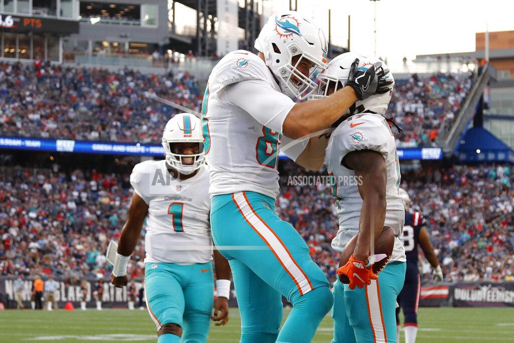 Winslow Townson Miami Dolphins wide receiver Jaylen Waddle, right, celebrates with Mike Gesicki after his touchdown during the second half of an NFL football game against the New England Patriots, Sunday, Sept. 12, 2021, in Foxborough, Mass. At left is Miami Dolphins quarterback Tua Tagovailoa (1). (AP Photo/Winslow Townson)