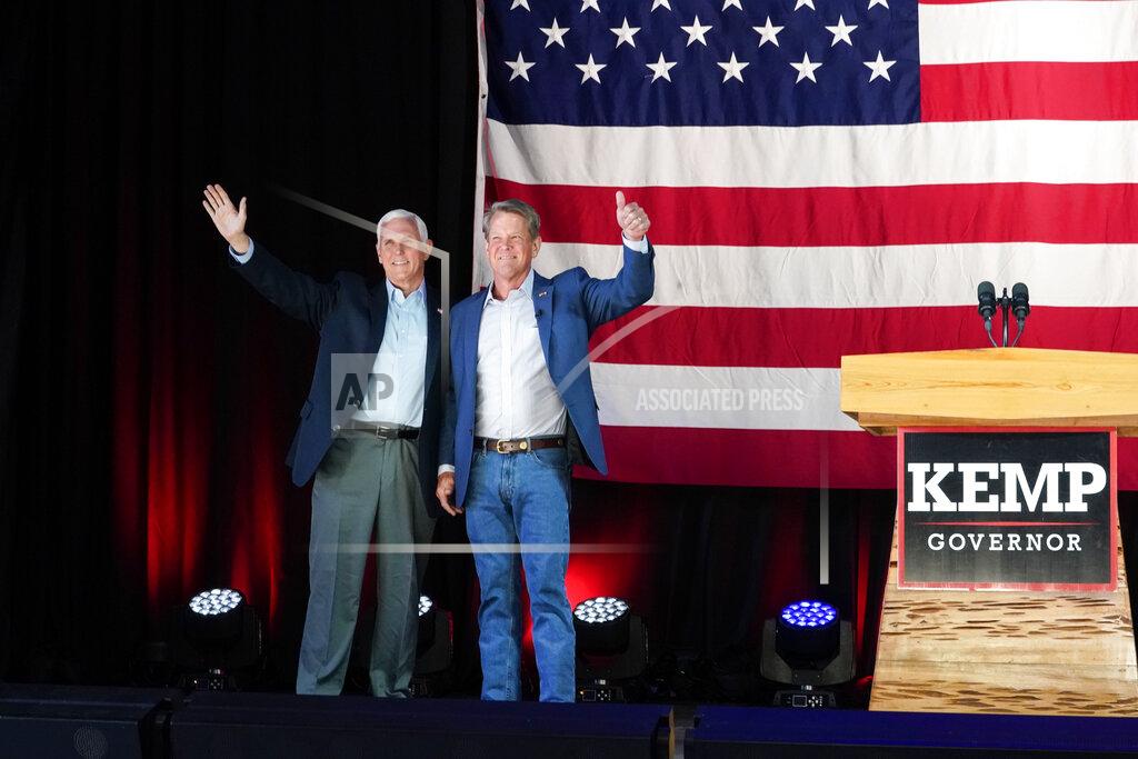 Brynn Anderson Former Vice President Mike Pence, left, and Georgia Gov. Brian Kemp greet the crowd during a rally, Monday, May 23, 2022, in Kennesaw, Ga. Pence is opposing former President Donald Trump and his preferred Republican candidate for Georgia governor, former U.S. Sen. David Perdue. (AP Photo/Brynn Anderson)