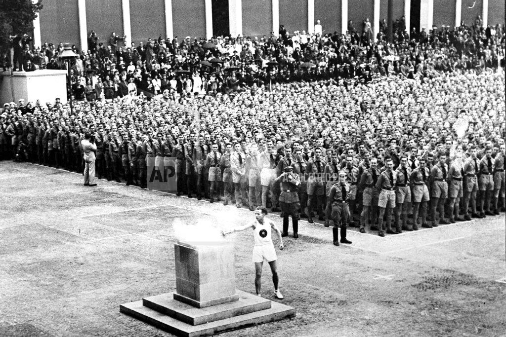 Uncredited The Olympic torch in Lustgarten, Berlin, is lit Aug. 1, 1936, where will be guarded by members of the Hitler Youth until it is brought to the Olympic stadium for the opening of the games in the afternoon. The torch relay was not always a fixture of the modern Olympics, which began in 1896. The relay tradition began with Adolph Hitler's 1936 Olympics in Berlin. (AP Photo)