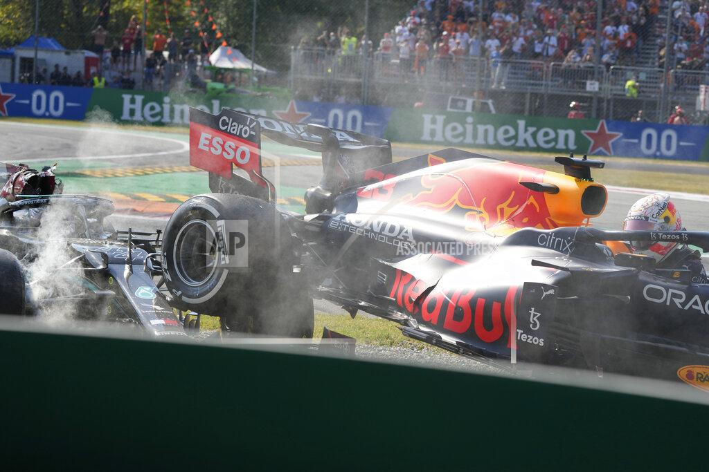 Luca Bruno Red Bull driver Max Verstappen of the Netherlands, right and Mercedes driver Lewis Hamilton of Britain crash during the Italian Formula One Grand Prix, at Monza racetrack, in Monza, Italy, Sunday, Sept.12, 2021. (AP Photo/Luca Bruno)