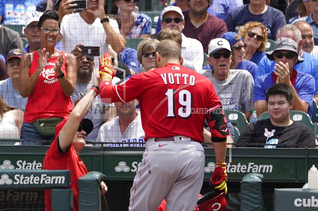 Charles Rex Arbogast Cincinnati Reds' Joey Votto celebrates his two-run home run off Chicago Cubs starting pitcher Alec Mills outside the dugout during the first inning of a baseball game Thursday, July 29, 2021, in Chicago. Jesse Winker also scored on the play. (AP Photo/Charles Rex Arbogast)