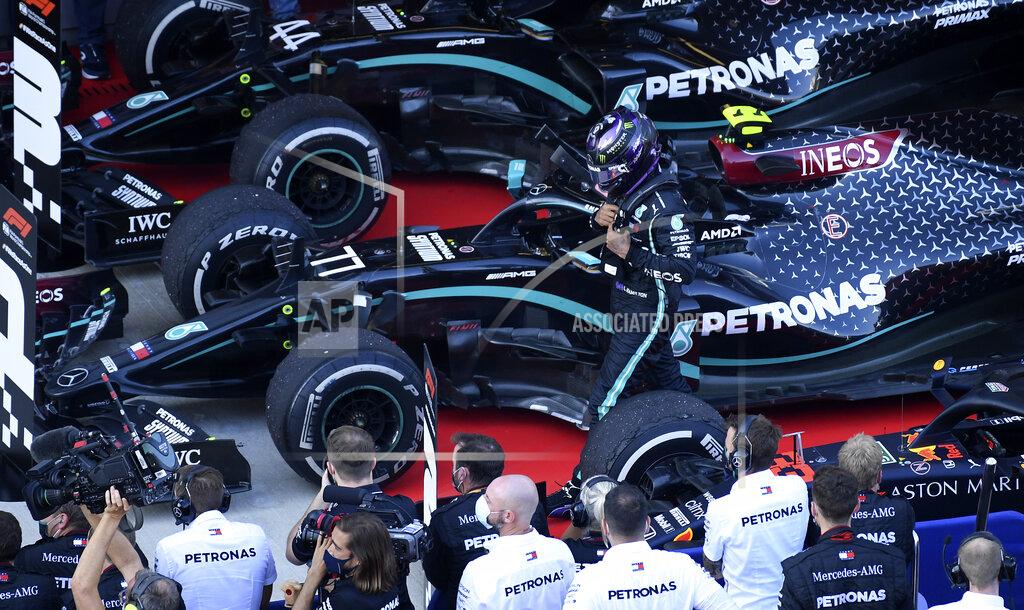 Kirill Kudryavtsev Mercedes driver Lewis Hamilton of Britain walks by his crew after placing third in the Russian Formula One Grand Prix, at the Sochi Autodrom circuit, in Sochi, Russia, Sunday, Sept. 27, 2020. (Kirill Kudryavtsev, Pool via AP)