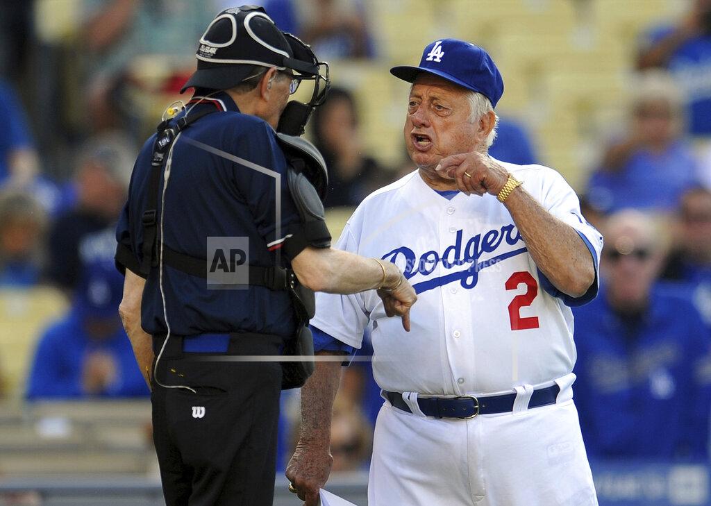 Keith Birmingham Former Los Angeles Dodgers manager Tommy Lasorda argues with home plate umpire Larry King, left, during the Old-Timers game prior to a baseball game between the Atlanta Braves and the Los Angeles Dodgers on Saturday, June 8, 2013, in Los Angeles. King, the suspenders-sporting everyman whose broadcast interviews with world leaders, movie stars and ordinary Joes helped define American conversation for a half-century, died Saturday, Jan. 23, 2021, at age 87. (Keith Birmingham/The Orange County Register/SCNG via AP)