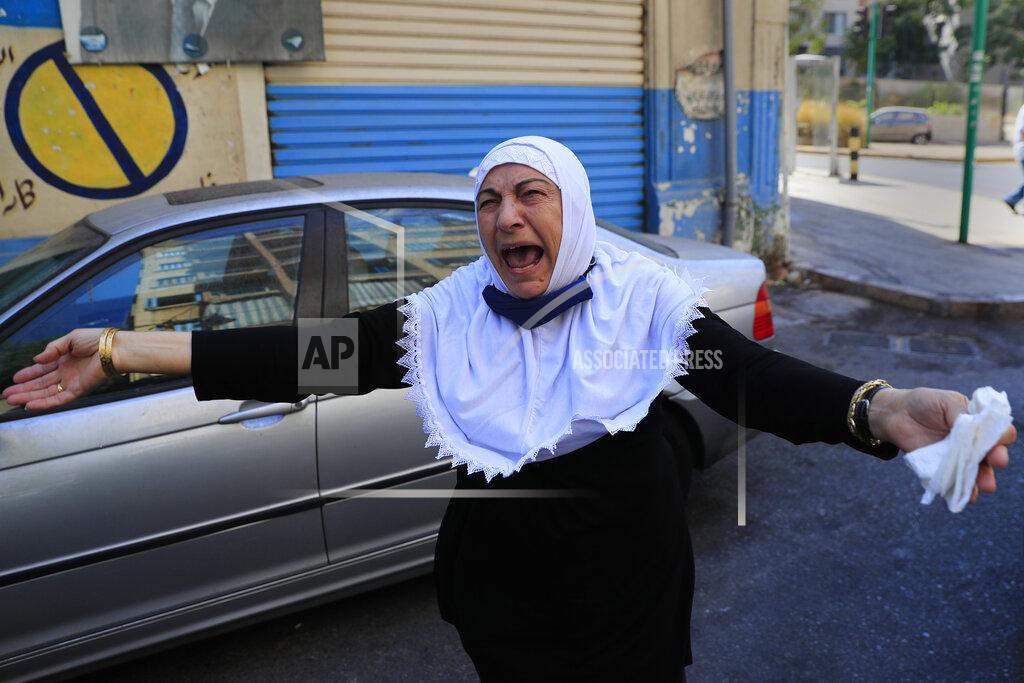 Hussein Malla The aunt of Ibrahim Harb, 35, a Lebanese man who was critically injured in the massive explosion at Beirut's port last year and who died on Monday evening nearly 14 months after the blast, mourns during his funeral procession, in Beirut, Lebanon, Tuesday, Sept. 28, 2021. On August 4, 2020, hundreds of tons of ammonium nitrate, a highly explosive material used in fertilizers, ignited after a massive fire at the port. The death brings to at least 215 the number of people who have been killed by the blast, according to official records. (AP Photo/Hussein Malla)