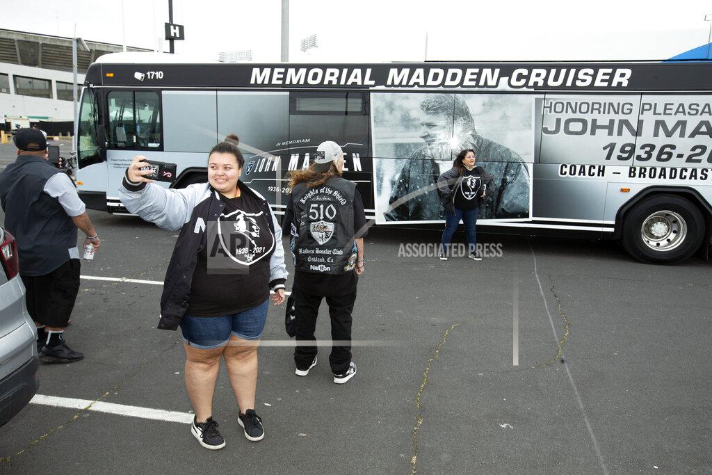 D. Ross Cameron Mercedes Walker, of Oakland, Calif., takes a photo in front of a "Maddencruiser" bus before a memorial service for former NFL football coach and television commentator John Madden, Monday, Feb. 14, 2022, in Oakland. Madden died last year at age 85. (AP Photo/D. Ross Cameron)