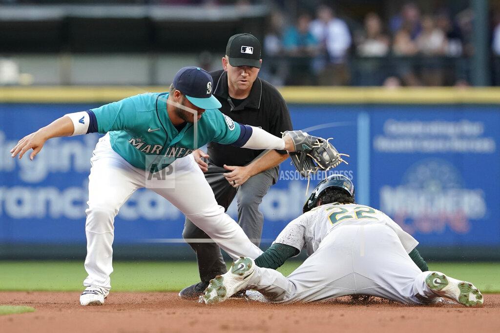 Ted S. Warren Oakland Athletics' Ramon Laureano, right, is caught stealing second base by Seattle Mariners second baseman Ty France, as umpire Mike Muchlinski watches during the second inning of a baseball game Friday, July 23, 2021, in Seattle. (AP Photo/Ted S. Warren)