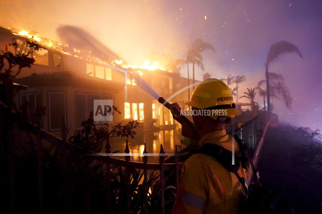 Marcio J. Sanchez A firefighter works to put at a structure burning during a wildfire Wednesday, May 11, 2022, in Laguna Niguel, Calif. (AP Photo/Marcio J. Sanchez)