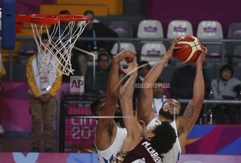 Fernando Llano Puerto Rico's Emmanuel Andujar takes a rebound over Venezuela's Michael Carrera during their basketball first round game at the Pan American Games in Lima, Peru, Wednesday, July 31, 2019. (AP Photo/Fernando Llano)