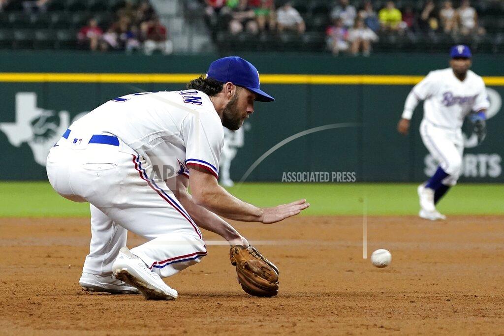 Tony Gutierrez Texas Rangers third baseman Charlie Culberson reaches down to field a grounder by Houston Astros' Chas McCormick, who was out at first during the second inning of a baseball game in Arlington, Texas, Tuesday, Sept. 14, 2021. (AP Photo/Tony Gutierrez)