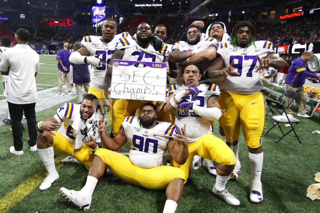 John Bazemore LSU players celebrate after the Southeastern Conference championship NCAA college football game against Georgia, Saturday, Dec. 7, 2019, in Atlanta. LSU won 37-10. (AP Photo/John Bazemore)