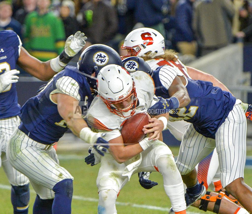 Howard Simmons Syracuse quarterback Tommy DeVito (13) is sacked by the Notre Dame defense during an NCAA college football game, Saturday, Nov. 17, 2018, at Yankee Stadium in New York. (AP Photo/Howard Simmons)