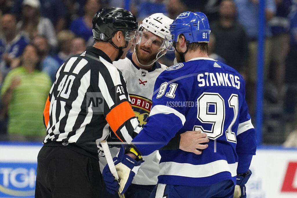Chris O'MEara NHL referee Steve Kozari (40) talks to Florida Panthers left wing Jonathan Huberdeau (11) and Tampa Bay Lightning center Steven Stamkos (91) after a goal by the Lightning was overturned during the second period in Game 4 of an NHL hockey second-round playoff series Monday, May 23, 2022, in Tampa, Fla. (AP Photo/Chris O'Meara)
