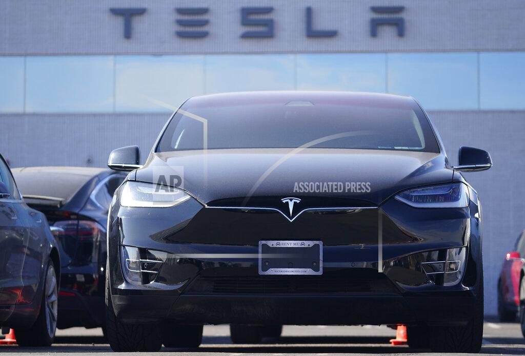 An unsold 2021 Model X sports-utility vehicle sits at a Tesla dealership Sunday, Jan. 24, 2021, in Littleton, Colo. Tesla reports earnings on Wednesday, Jan. 21. (AP Photo/David Zalubowski)