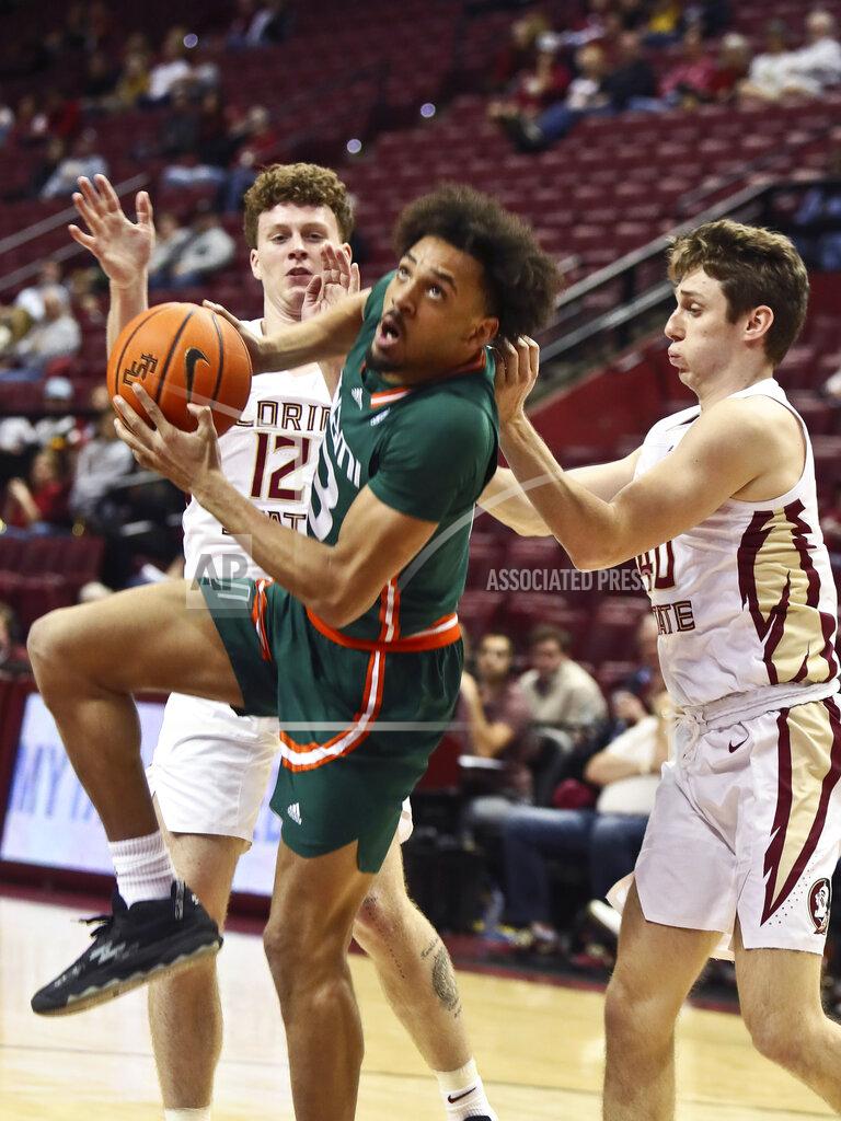 Phil Sears Miami guard Jakai Robinson (13) lunges towards the basket to make a layup past Florida State guards Tom House (12) and Isaac Spainhour (40) in the second half of an NCAA college basketball game in Tallahassee, Fla., Tuesday, Jan. 24, 2023. (AP Photo/Phil Sears)