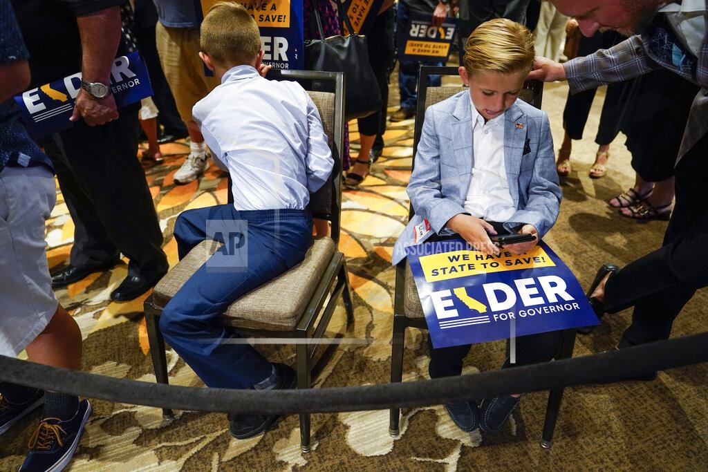 Ashley Landis Two boys and other supporters of republican conservative radio show host Larry Elder wait for results after polls close for the California gubernatorial recall election Tuesday, Sept. 14, 2021, in Costa Mesa, Calif. The rare, late-summer election, which challenged California Governor Gavin Newsom, has emerged as a national battlefront on issues from COVID-19 restrictions to climate change. (AP Photo/Ashley Landis)