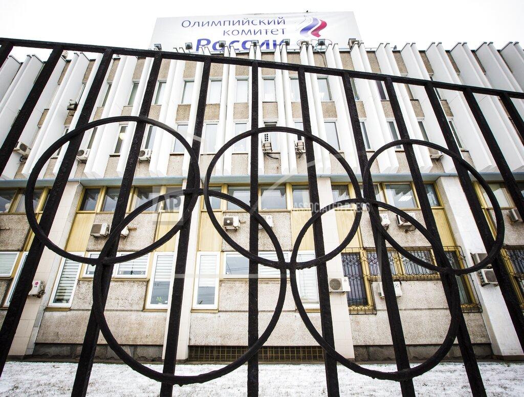 FILE - In this Dec. 6, 2017, file photo, the building of the Russian Olympic Committee is seen through a gate decorated with the Olympic rings, in Moscow, Russia. The ruling on whether Russia can keep its name and flag for the Olympics will be announced on Thursday Dec. 17, 2020. The Court of Arbitration for Sport said Wednesday that three of its arbitrators held a four-day hearing last month in the dispute between the World Anti-Doping Agency and its Russian affiliate, known as RUSADA. (AP Photo/Alexander Zemlianichenko, File)