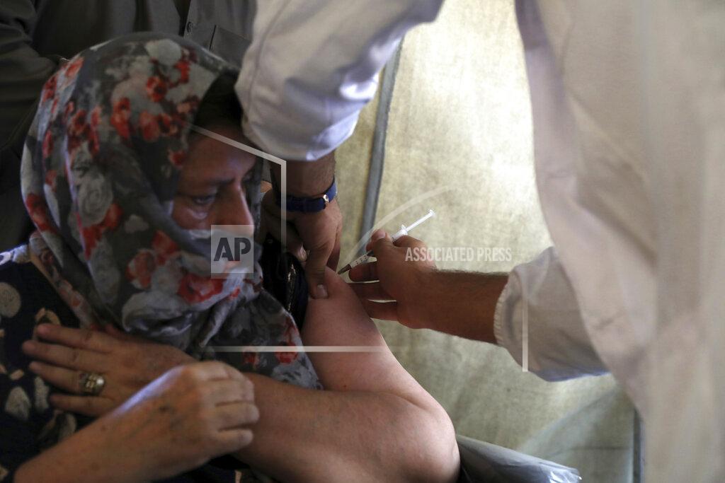 Rahmat Gul FILE - In this Sunday, July 11, 2021 file photo, a woman receives the Johnson & Johnson COVID-19 vaccine at a vaccination center in Kabul, Afghanistan, donated by the United States and delivered through the U.N.-backed COVAX program. In late June, the international system for sharing coronavirus vaccines sent about 530,000 doses to Britain – more than double the amount sent that month to the entire continent of Africa. It was the latest example of how a system that was supposed to guarantee low and middle-income countries vaccines is failing, leaving them at the mercy of haphazard donations from rich countries. (AP Photo/Rahmat Gul, file)