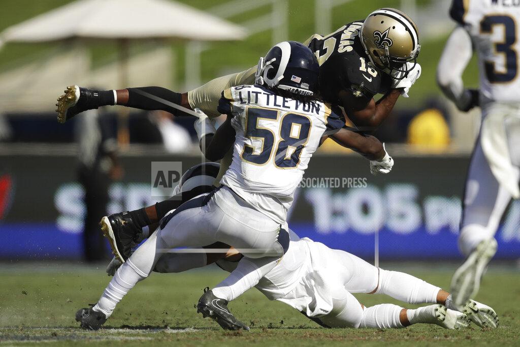 FILE - In this Sept. 15, 2019, file photo, New Orleans Saints wide receiver Michael Thomas, top, is tackled by Los Angeles Rams inside linebacker Cory Littleton during the second half of an NFL football game in Los Angeles. The Las Vegas Raiders have agreed with free agent linebacker Cory Littleton on a three-year contract. A person familiar with the contract says the sides came to agreement on the deal to give the Raiders a major upgrade at linebacker. The person spoke on condition of anonymity because the contract can't be signed until the start of the new league year on Wednesday, March 18, 2020. (AP Photo/Marcio Jose Sanchez, File)
