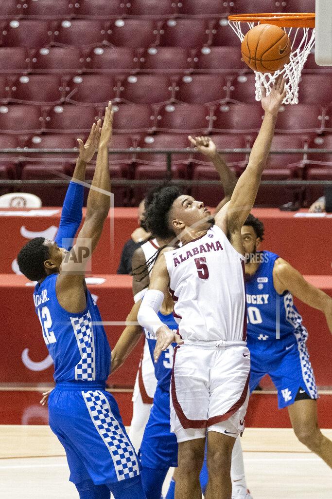 Vasha Hunt Alabama guard Jaden Shackelford (5) gets by Kentucky forward Keion Brooks Jr (12) for a shot during the second half of an NCAA college basketball game, Tuesday, Jan. 26, 2021, in Tuscaloosa, Ala. (AP Photo/Vasha Hunt)