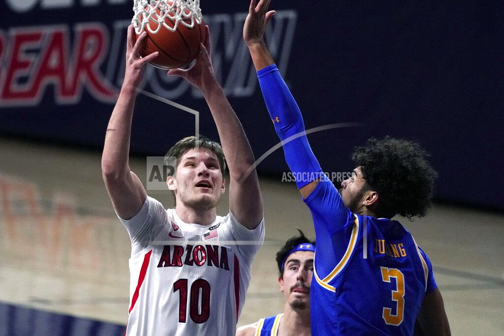 Rick Scuteri Arizona forward Azuolas Tubelis (10) drives on UCLA guard Johnny Juzang (3) during the first half of an NCAA college basketball game Saturday, Jan. 9, 2021, in Tucson, Ariz. (AP Photo/Rick Scuteri)