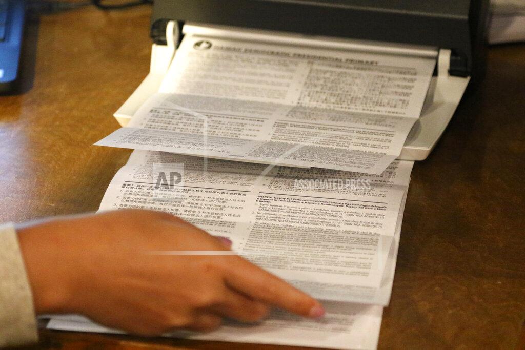 Caleb Jones Democratic Party of Hawaii staff tabulate presidential primary ballots in Honolulu on Friday, May 22, 2020. The Democratic Party of Hawaii is scheduled Saturday to release the results of its party-run presidential primary which was delayed by more than a month due the coronavirus pandemic. The party expected most members to vote by mail and some to cast ballots at about 20 in-person polling sites. But concerns about the virus forced the party to cancel in-person voting and allow only mail ballots. (AP Photo/Caleb Jones)