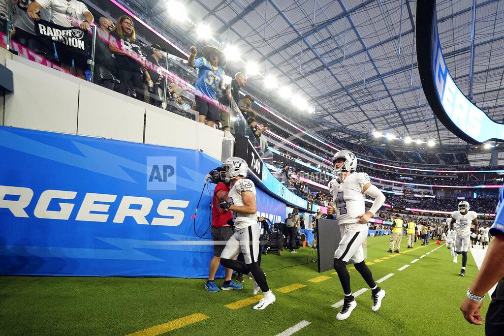 Ashley Landis Las Vegas Raiders quarterback Derek Carr (4) and other players leave the field due to a weather delay shortly before the scheduled start an NFL football game against the Los Angeles Chargers, Monday, Oct. 4, 2021, in Inglewood, Calif. (AP Photo/Ashley Landis)