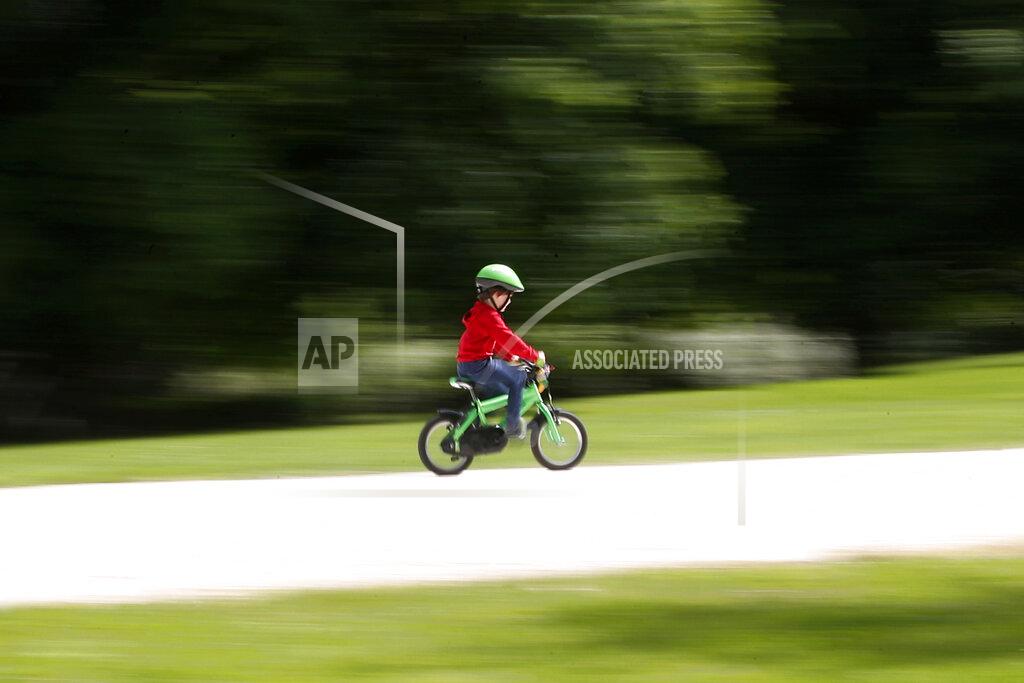 Antonio Calanni FILE - In this May 4, 2020 file photo, a child rides a bicycle in a park which reopened after several weeks of closure, due coronavirus lockdown restrictions, in Milan, Italy. A national survey of the psychological impact of coronavirus lockdowns on Italian children presented in Rome on Tuesday, June 16, 2020, has quantified what many parents noticed offhand during weeks cooped up at home: Their kids were more irritable, had trouble sleeping and for some of the youngest, wept inconsolably and regressed developmentally. (AP Photo/Antonio Calanni, fiel)