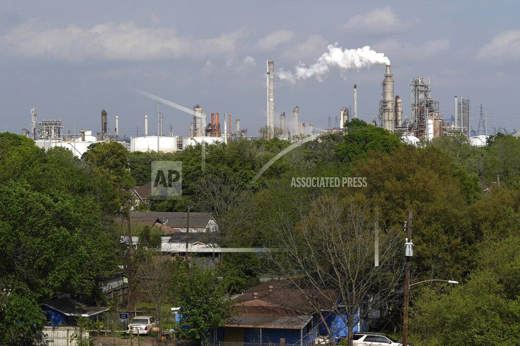 David J. Phillip Homes are seen with The Valero Houston Refinery in the background on Monday, March 23, 2020, in Houston. The Texas Gulf Coast is the United States’ petrochemical corridor, with four of the country’s 10 biggest oil and gas refineries and thousands of chemical facilities. (AP Photo/David J. Phillip)