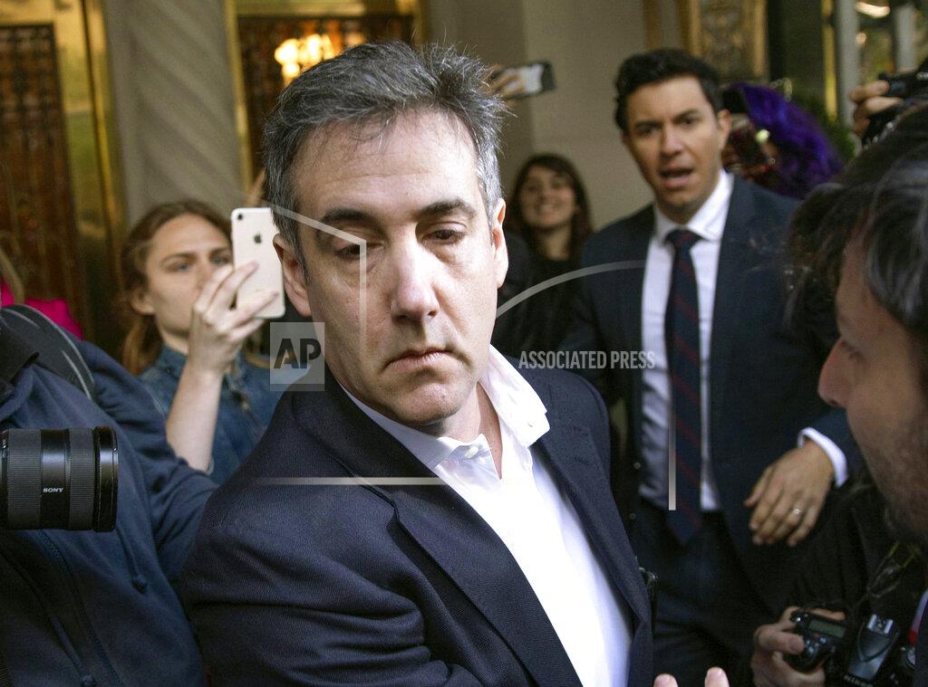 Kevin Hagen FILE - In this May 6, 2019, file photo, Michael Cohen, former attorney to President Donald Trump, leaves his apartment building before beginning his prison term in New York. Cohen pleaded guilty to orchestrating payments made during President Trump's 2016 campaign to porn actress Stormy Daniels and model Karen McDougal, to prevent them from publicly alleging they had extramarital affairs with him. (AP Photo/Kevin Hagen, File)