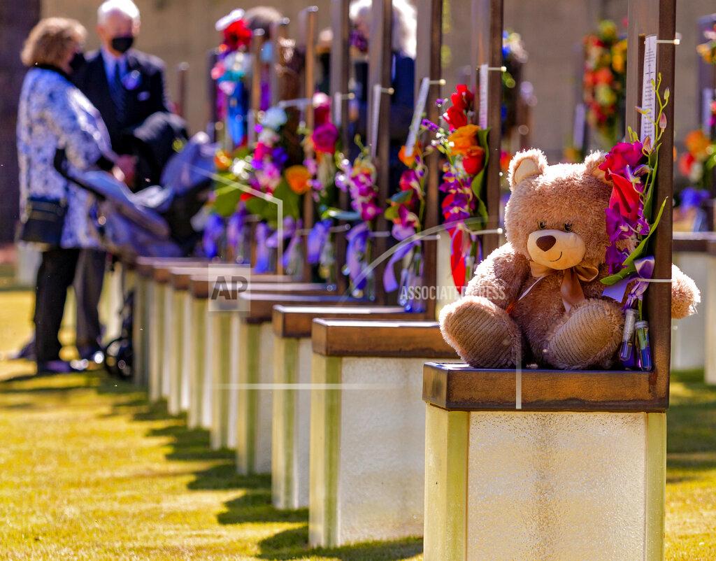 Chris Landsberger Flowers and gifts decorate the memorial chairs in the Field of Chairs for the 26th Anniversary Remembrance Ceremony at the Oklahoma City National Memorial and Museum in Oklahoma City, Okla on Monday, April 19, 2021. (Chris Landsberger/The Oklahoman via AP)