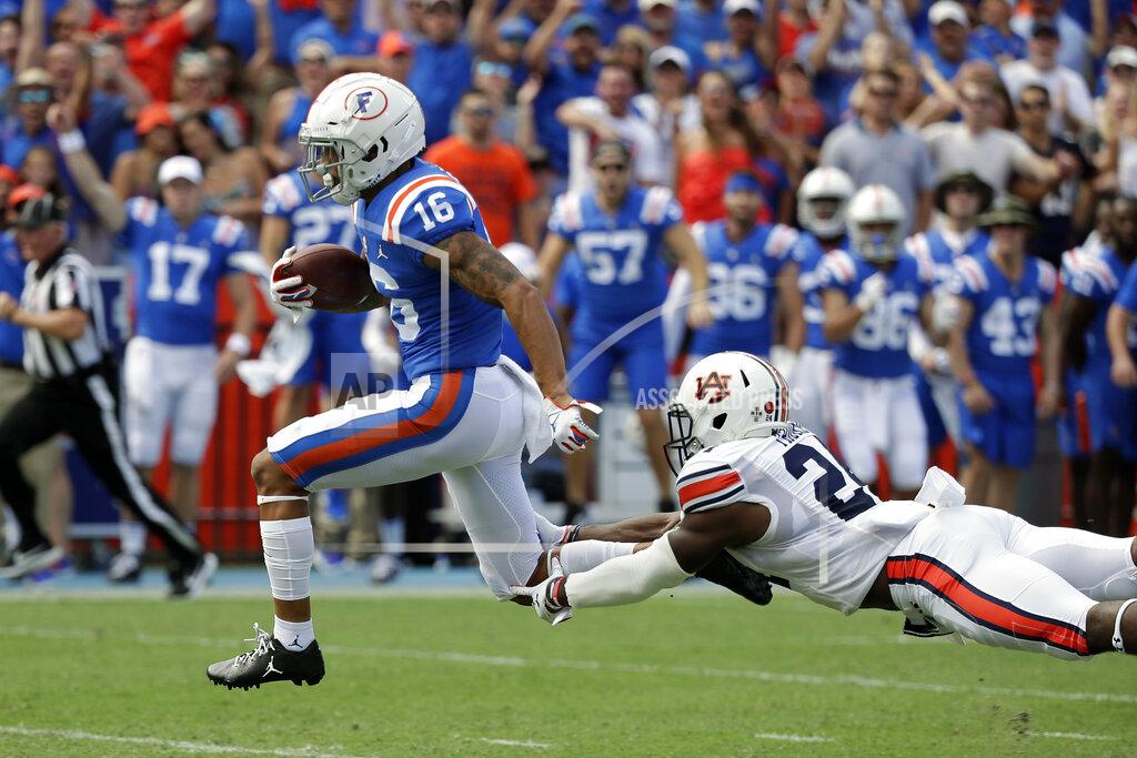 John Raoux Florida wide receiver Freddie Swain (16) outruns a tackle by Auburn defensive back Daniel Thomas on his way to a 64-yard touchdown during the first half of an NCAA college football game, Saturday, Oct. 5, 2019, in Gainesville, Fla. (AP Photo/John Raoux)