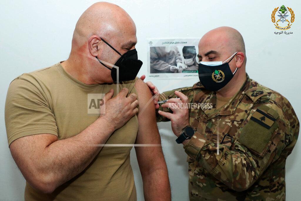 Uncredited In this photo released by the Lebanese Army official website, Lebanese Army Commander Gen. Joseph Aoun, receives a Sinopharm COVID-19 vaccine, at one of the military vaccination centers, in Beirut, Lebanon, Thursday, April 8, 2021. The Lebanese army said Aoun was the first to get the vaccine and that thousands of soldiers will be vaccinated in the coming weeks. Lebanon received a gift of 90,000 Sinopharm shots from China last week. (Lebanese Army Website via AP)