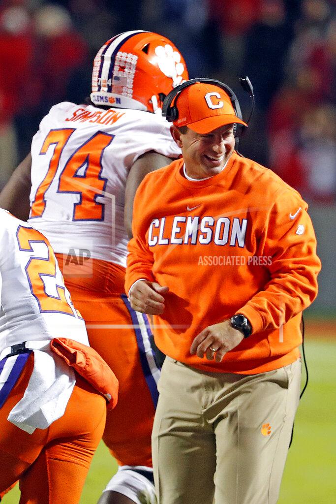 Karl B Deblaker Clemson head coach Dabo Swinney congratulates Clemson's John Simpson (74) during the first half of an NCAA college football game against North Carolina State in Raleigh, N.C., Saturday, Nov. 9, 2019. (AP Photo/Karl B DeBlaker)