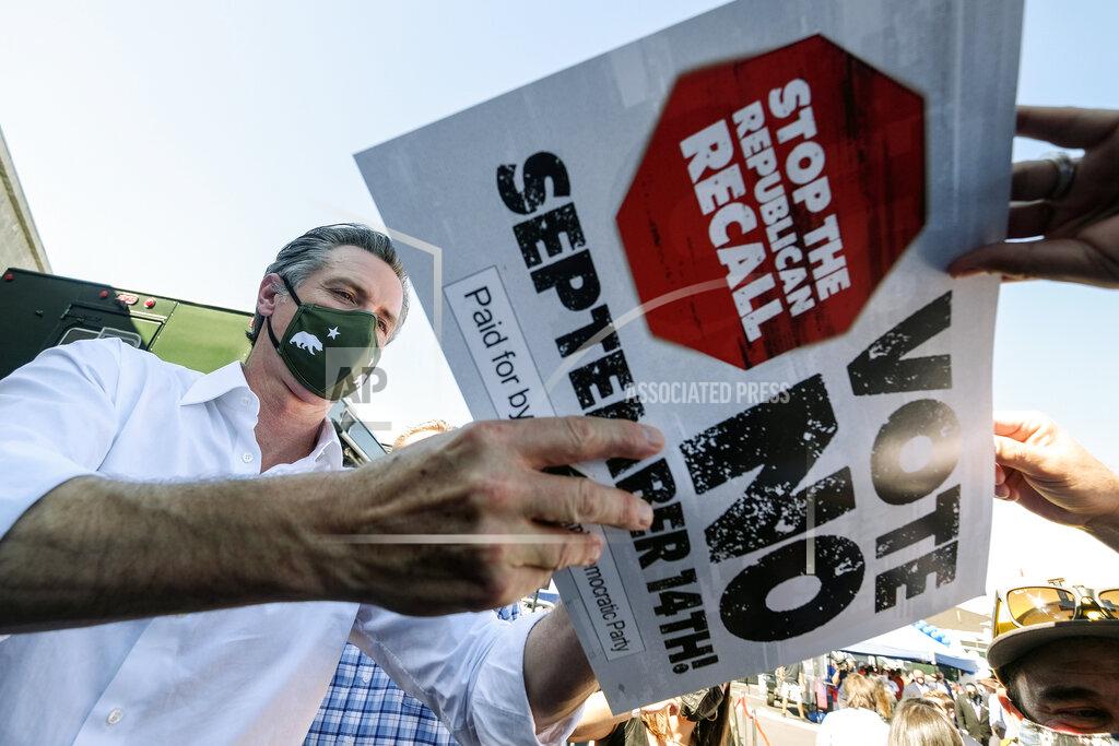 Ringo H.W. Chiu California Gov. Gavin Newsom signs autography for supporters at a rally against the California gubernatorial recall election on Sunday, Sept. 12, 2021, in Sun Valley, Calif. (AP Photo/Ringo H.W. Chiu)