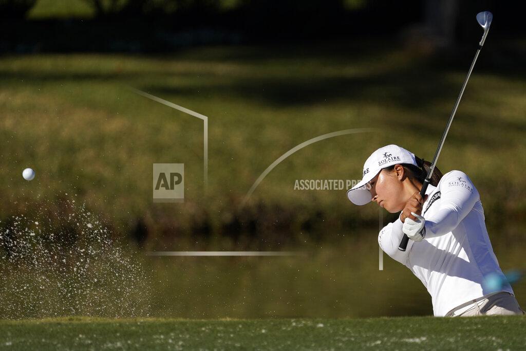 David J. Phillip Jin Young Ko, of Korea, hits out of a bunker on the 11th hole during a practice round at the U.S. Women's Open golf championship Tuesday, Dec. 8, 2020, in Houston.(AP Photo/David J. Phillip)