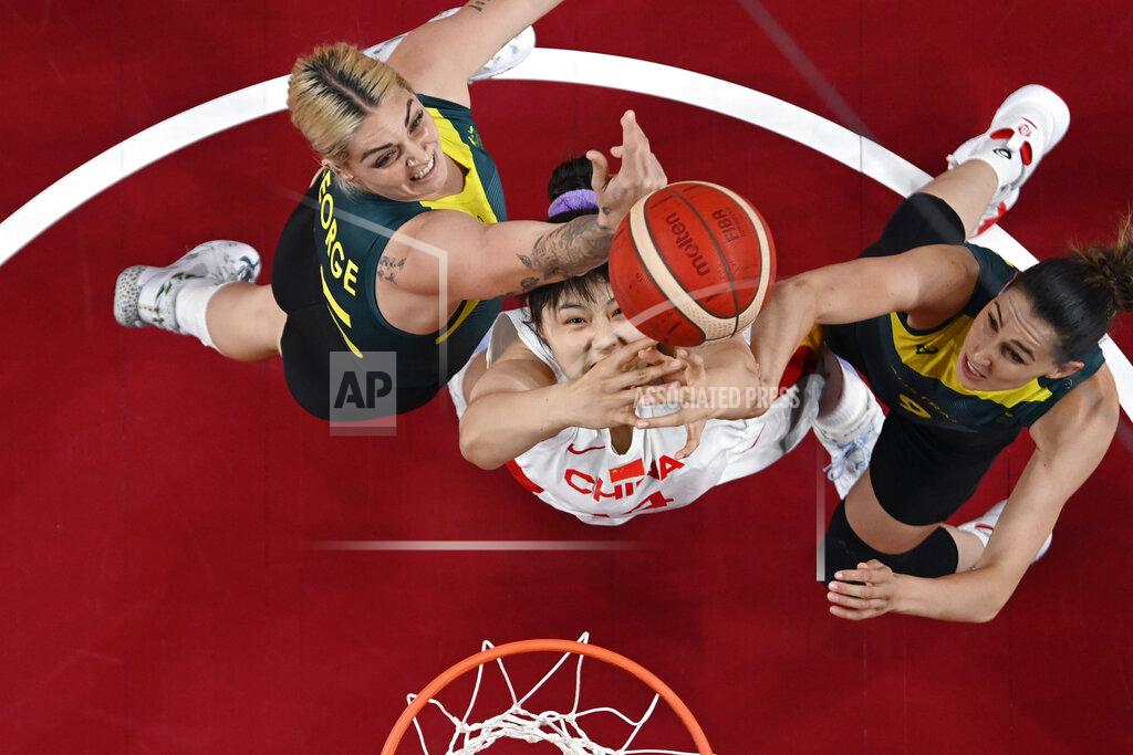 Aris Messinis China's Yueru Li, center, drives to the basket between Australia's Cayla George,left, and Bec Allen, right, during a women's basketball game at the 2020 Summer Olympics, Wednesday, July 28, 2021, in Saitama, Japan. (Aris Messinis/Pool Photo via AP)