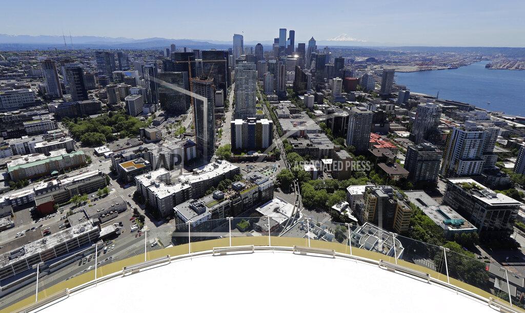 Downtown Seattle and mostly empty streets are shown, Wednesday, May 27, 2020, as viewed from the Space Needle. Many workers continue to work from home due to stay-at-home orders intended to prevent the further spread of the coronavirus. (AP Photo/Ted S. Warren)