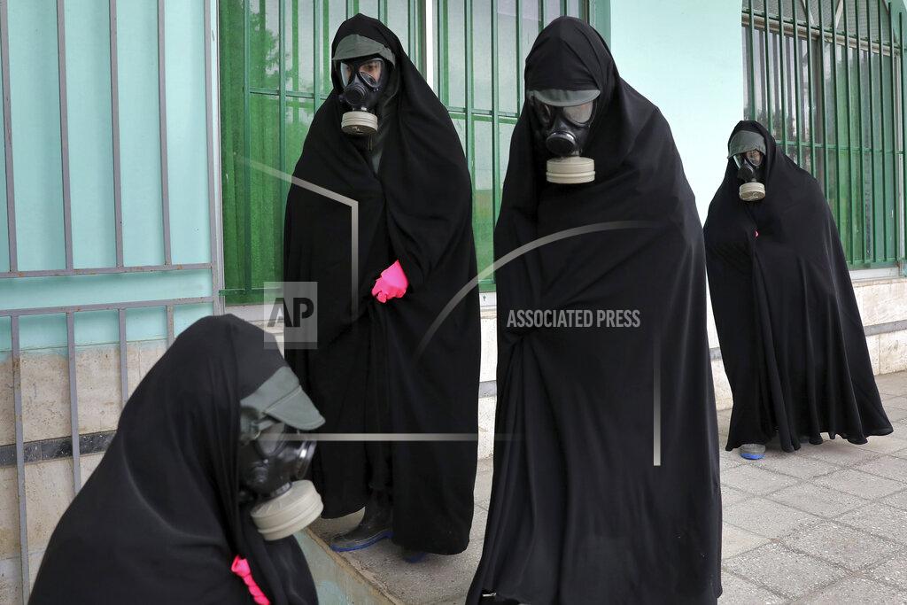 Ebrahim Noroozi Women clerics wearing protective clothing and "chador," a head-to-toe garment, arrive at a cemetery to prepare the body of a person who died from COVID-19 for a funeral, in Ghaemshahr, Iran, on April 30, 2020. (AP Photo/Ebrahim Noroozi)