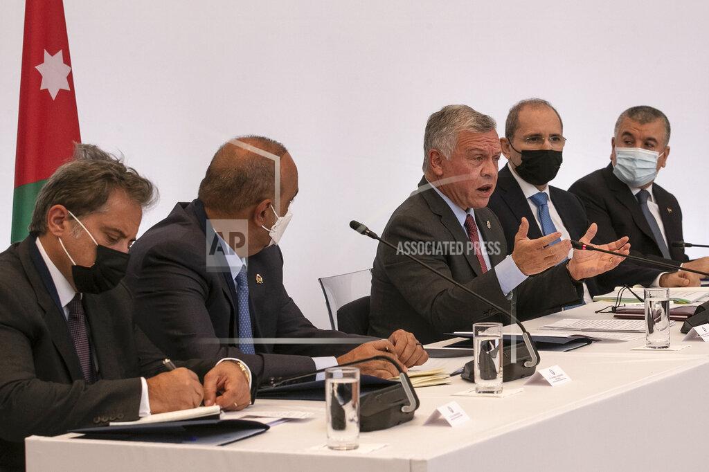 Yorgos Karahalis Jordan's King Abdullah II, center, speaks during a meeting in Athens, on Wednesday, July 28, 2021. Greece is hosting a one-day trilateral meeting of the three leaders. (AP Photo/Yorgos Karahalis)