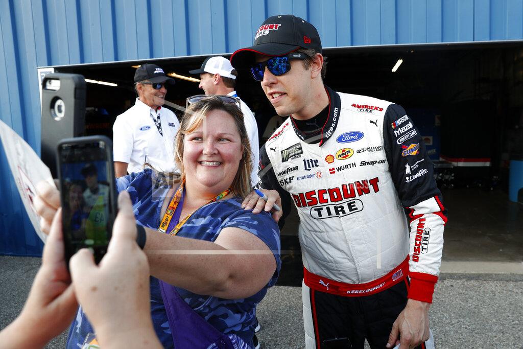 Paul Sancya Brad Keselowski poses for a photo after winning the pole for the NASCAR Cup Series auto race at Michigan International Speedway in Brooklyn, Mich., Friday, Aug. 9, 2019. (AP Photo/Paul Sancya)