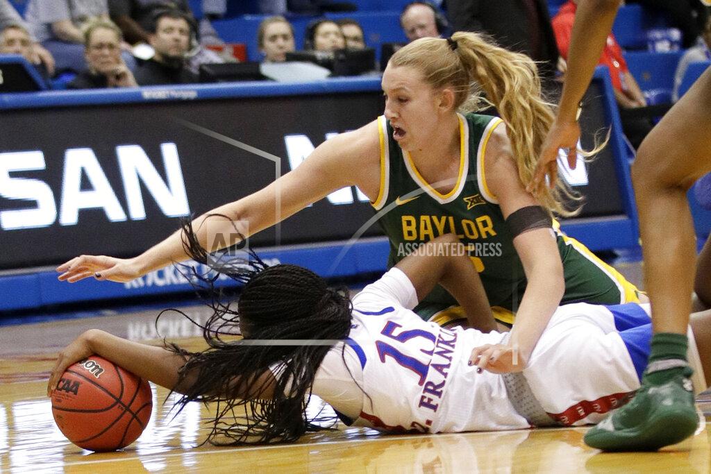 Baylor forward Lauren Cox, top, and Kansas guard Zakiyah Franklin (15) dive for the ball during the second half of an NCAA college basketball game in Lawrence, Kan., Wednesday, Jan. 15, 2020. (AP Photo/Orlin Wagner)