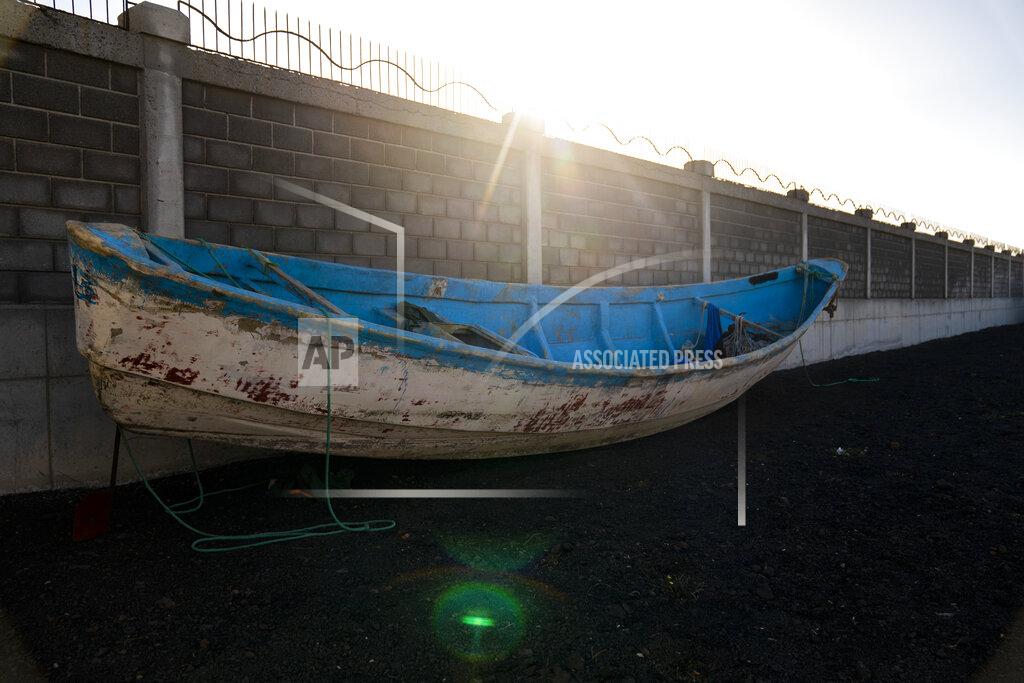 Emilio Morenatti A wooden boat carrying the remains of migrant belongings is seen at the Arinaga port in Gran Canaria island, on Wednesday, Aug. 19, 2020. Some 4,000 migrants have reached the Canaries so far this year, the most in over a decade, raising alarm at the highest levels of the Spanish government. (AP Photo/Emilio Morenatti)